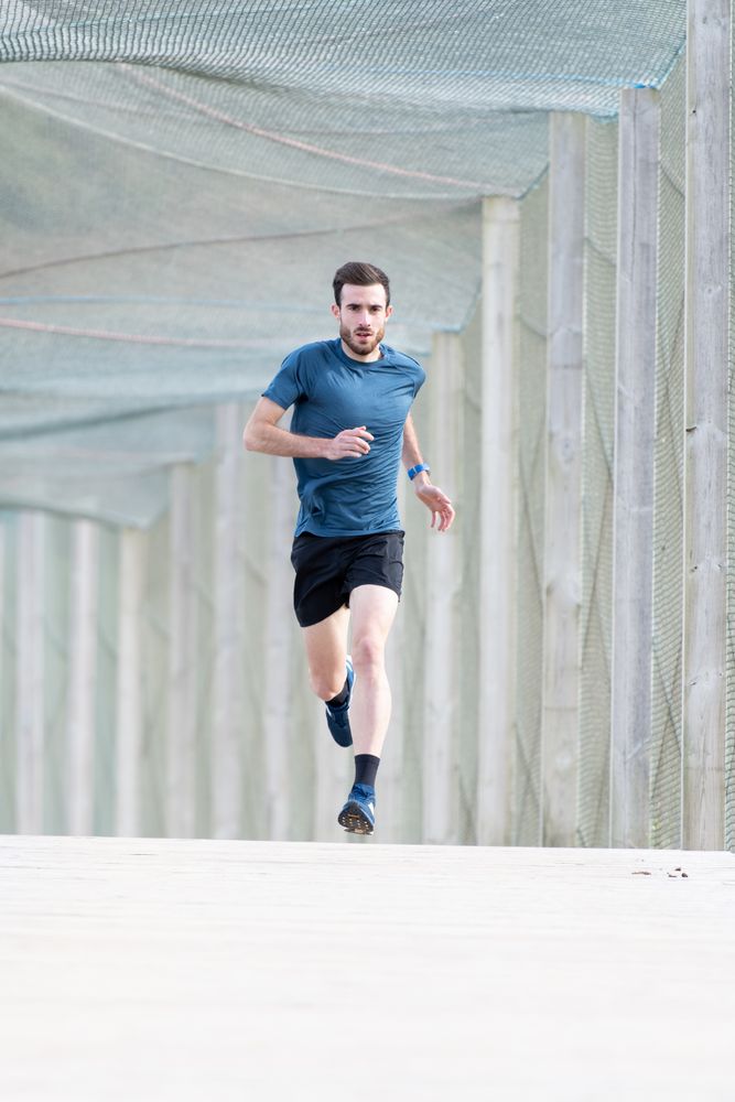 Sportsman jogging outdoors under cover