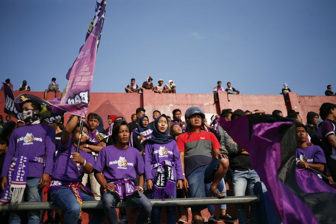 Kedira, East Java Indonesia - October 4, 2019: Soccer fans dressed in purple in the stands