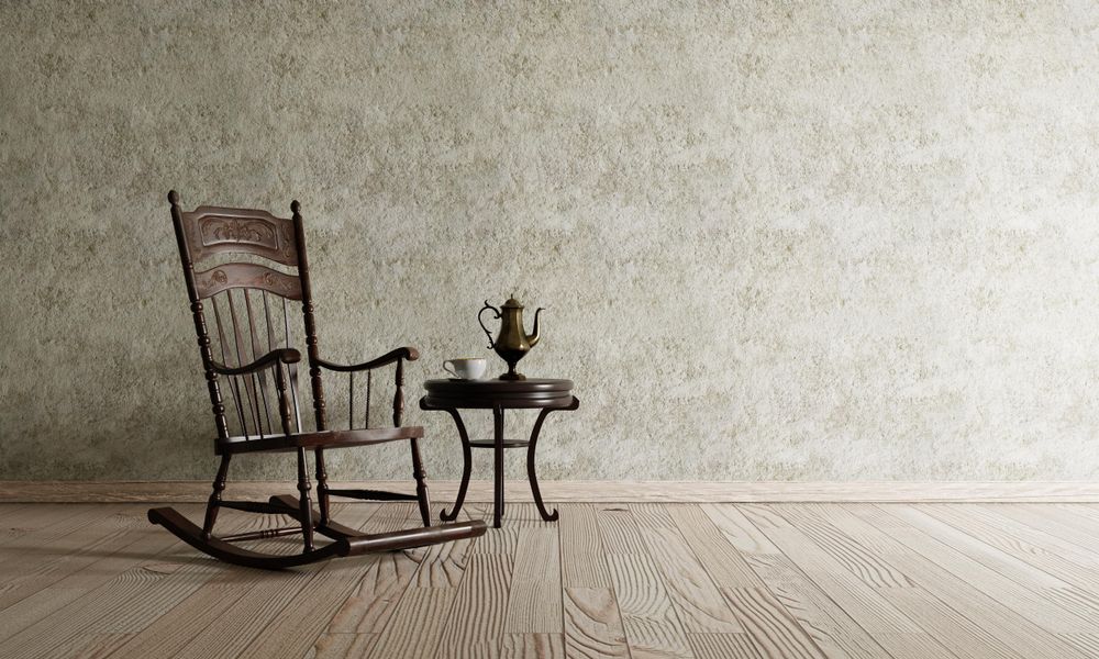 Minimal clean room with rocking chair and metal tea pot