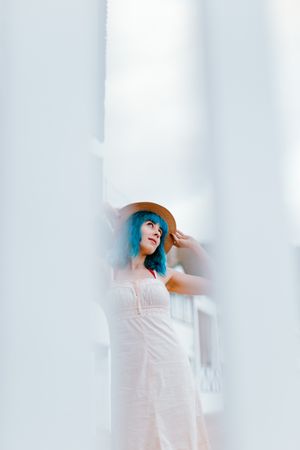 Carefree woman in sundress walking along sunny street