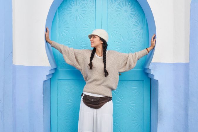 Smiling woman posing near vintage door