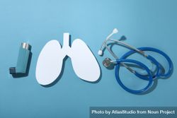 Lungs, inhaler, and stethoscope on blue background 5RmrN0