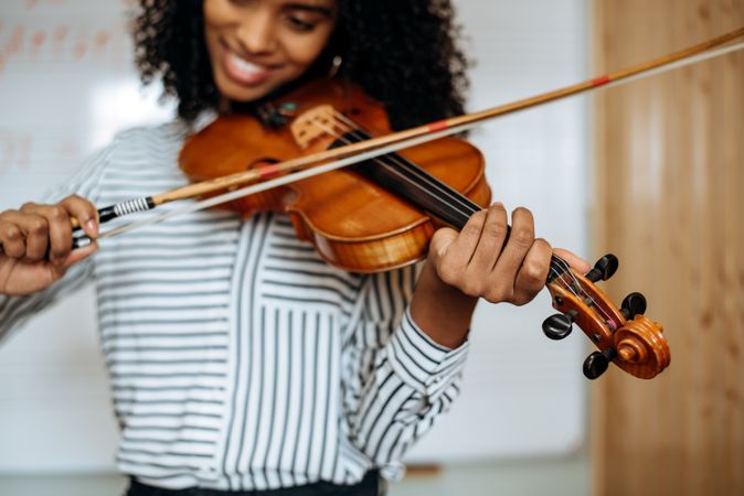 Woman playing violin in studio