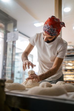 Arabic baker making shape on bread dough