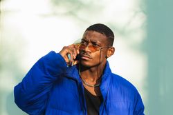 Stylish Black man in sunglasses on street