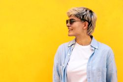 stylish young woman with short hair, sunglasses and hair wicks smiling. portrait