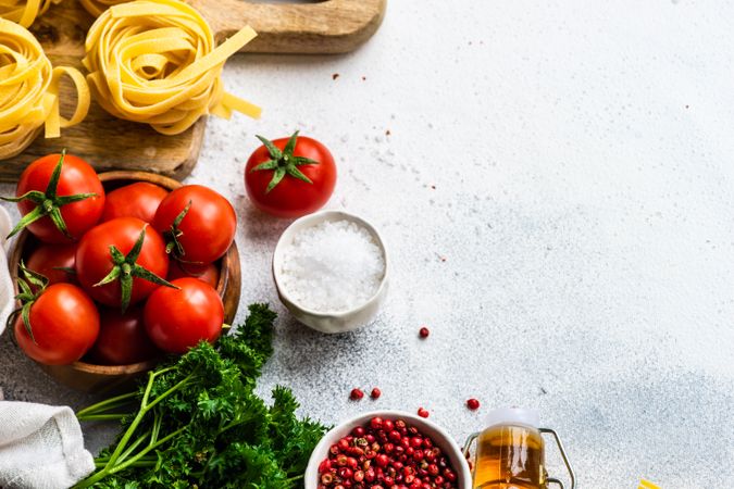 Fettuccine pasta and fresh vegetables on counter with copy space