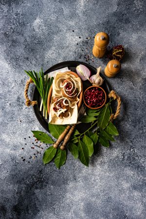 Top view of Georgian dish of abkhazura meat cutlets on plate with spring onions