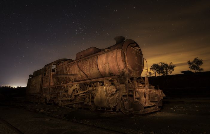 Old deserted train and sky with stars at night