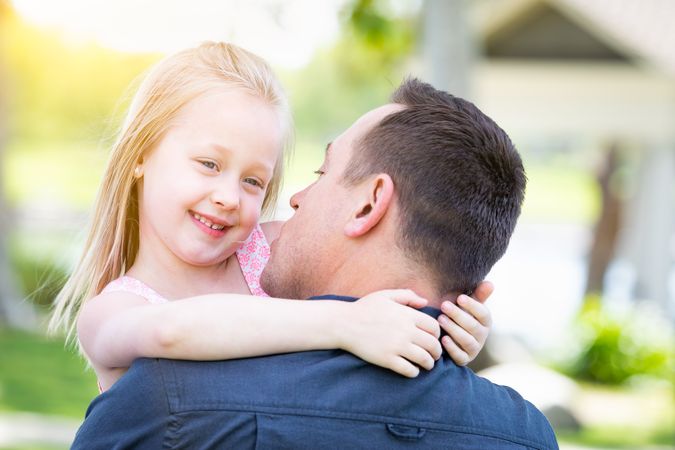 Young White Father and Daughter Having Fun At The Park
