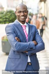 Happy male in business attire standing with arms crossed European street 4O7pL4