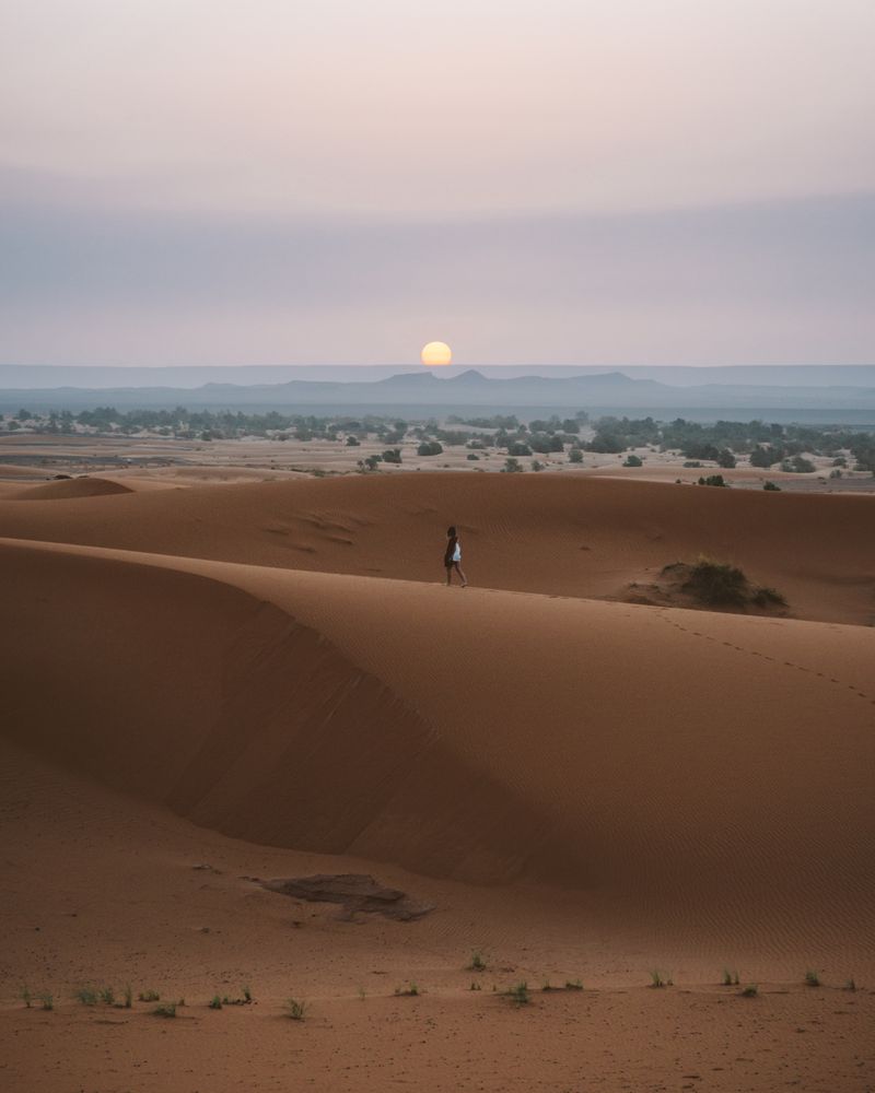 Woman in summer dress walking in desert