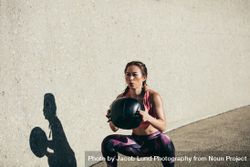 Sportswoman doing squat exercises with fitness ball bemVAb