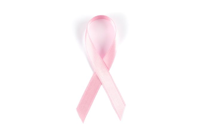 Pink awareness ribbon isolated on blank background, top view