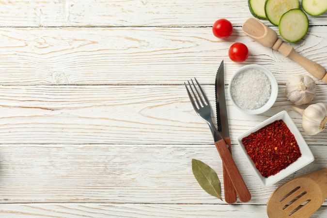 Composition with kitchen cutlery and ingredients for cooking on wooden background, top view