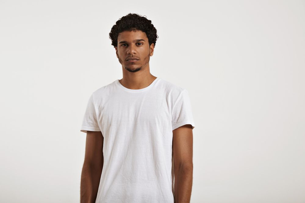 Portrait of Black man with neutral expression and plain t-shirt in studio shoot