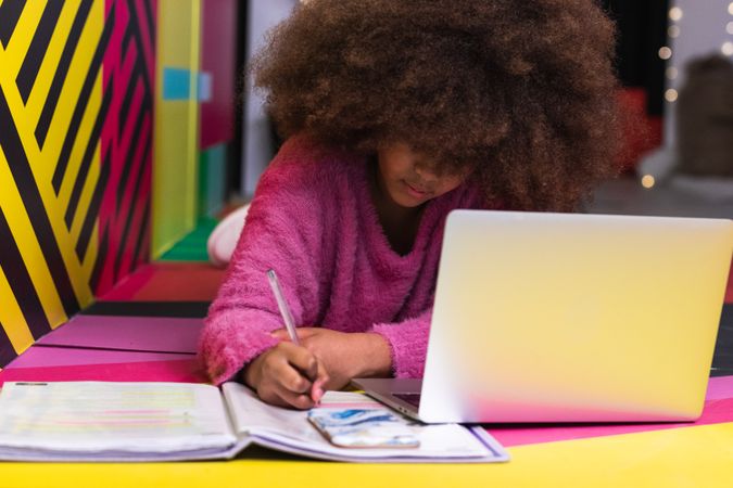 Black girl using laptop in studio