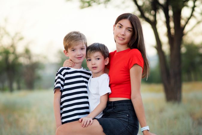 Loving mom with two sons outdoors