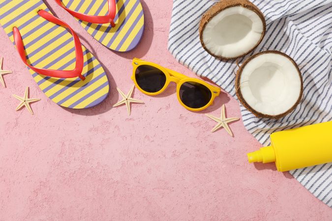 Summer vacation accessories on pink background, space for text