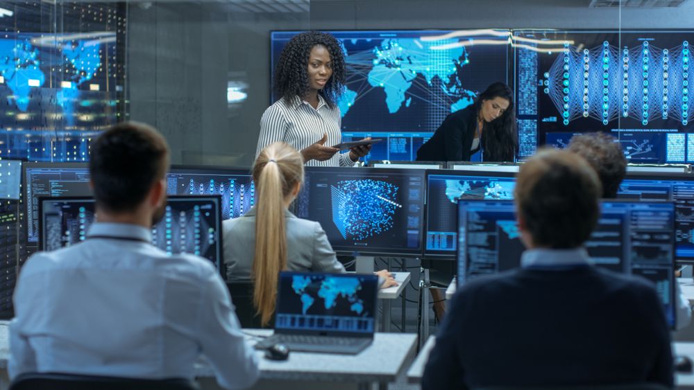 Chief Project Engineer Holds Briefing for a Team of Scientists that are Building Machine Learning System.
