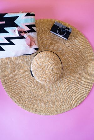 Summer trendy sunglasses, towel, hat and camera
