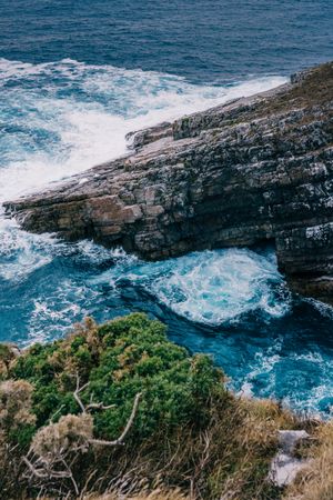 Sea waves crashing near cliff