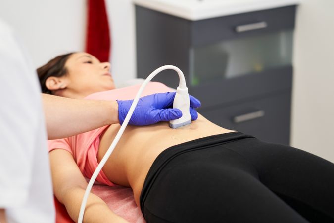 a physiotherapist performing an ultrasound scan for pelvic floor