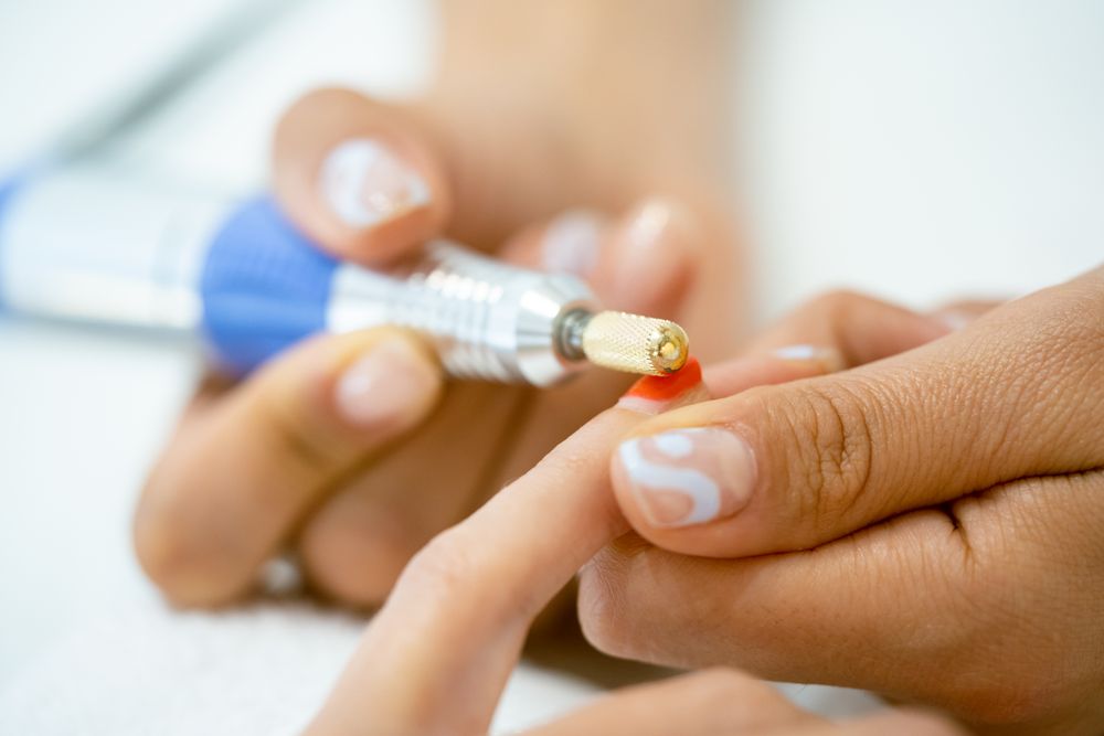 Close up of nails being buffed with professional equipment