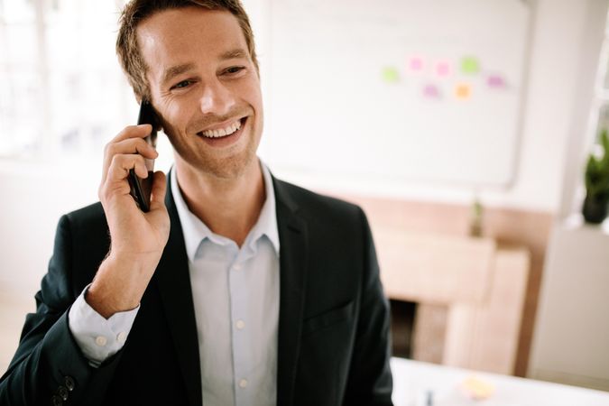 Professionally dressed male talking on mobile phone