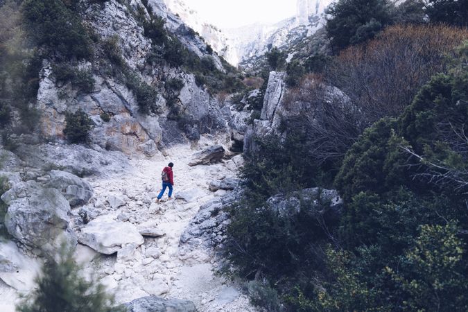 Woman walking between stone hills