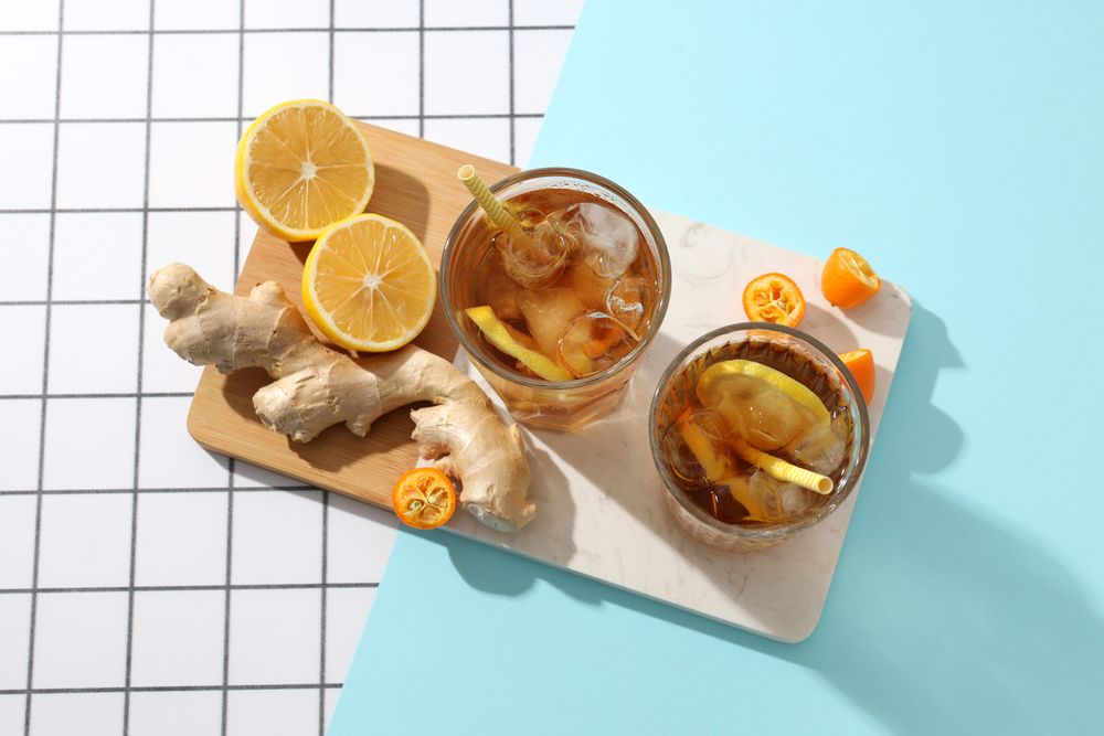 Cold tea with ice, orange slices and mint leaves and ginger