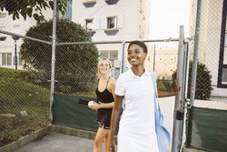Two friends getting in a tennis court