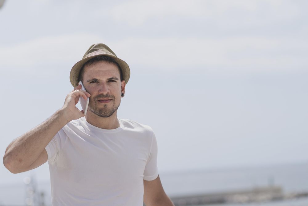 Male speaking on phone outside, copy space