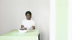 Black Woman Enjoying a Healthy Breakfast Indoors with Natural Light.