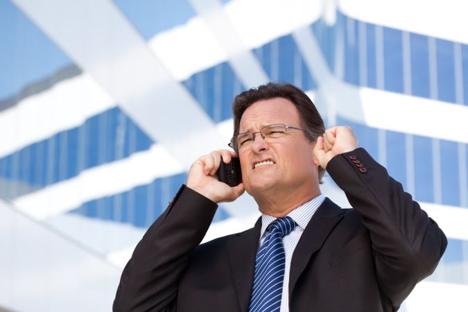 Excited Businessman on Cell Phone