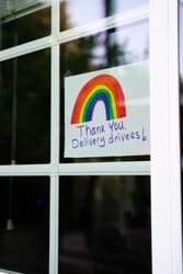 Close up of sign in-between window panes thanking delivery drivers during quarantine