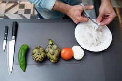 Top view of man prepping seafood in kitchen