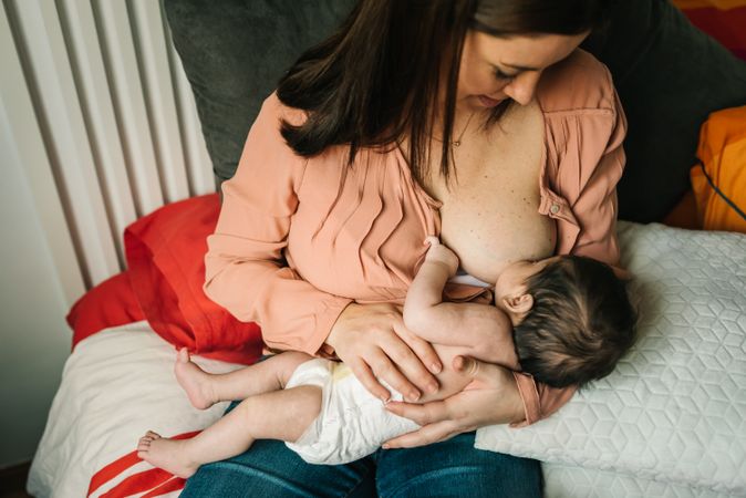 Mom breastfeeding at home