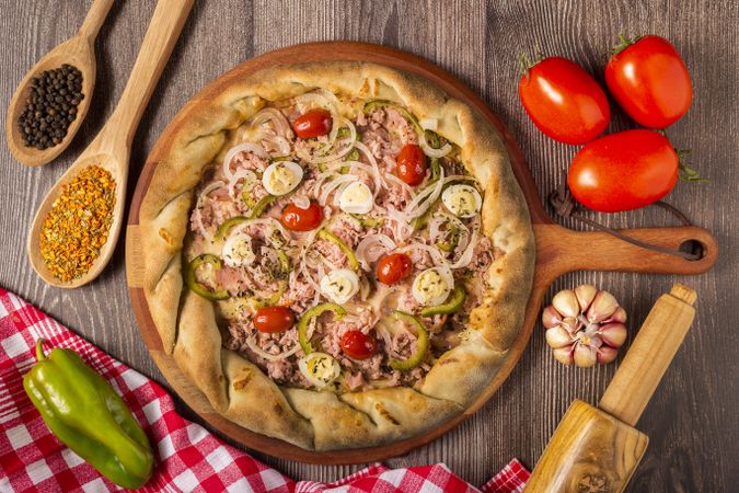 Wooden table with ingredients for pizza.