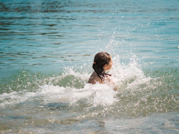 Cheerful girl having fun in warm sea