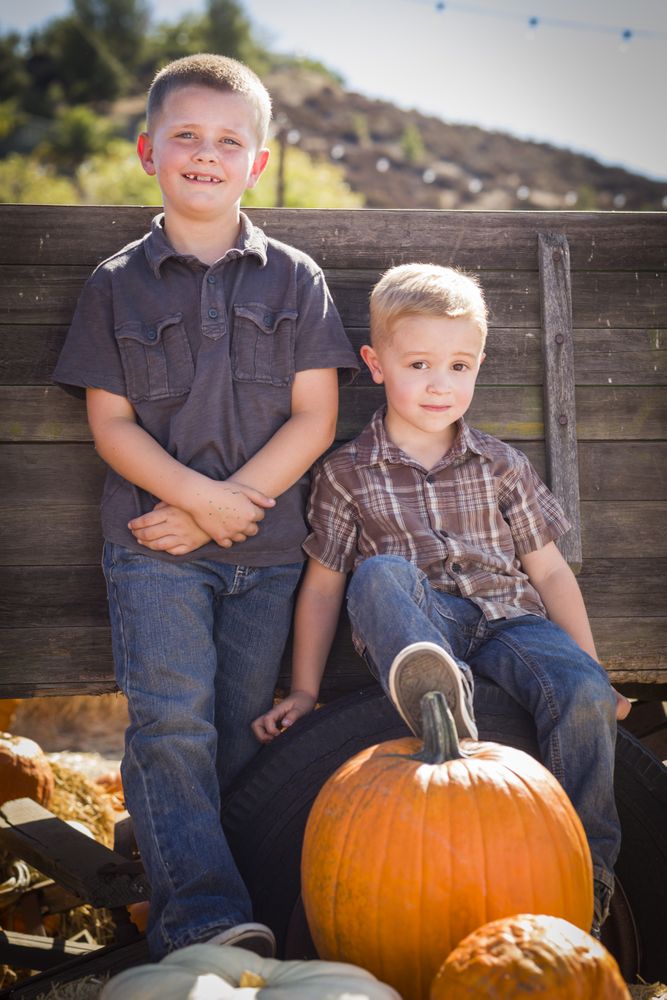 Boys at the Pumpkin Patch Against Antique Wood Wagon