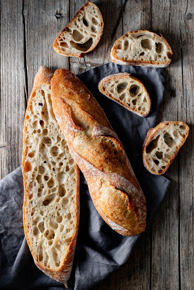 Fresh baguettes on checkered towel