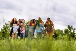 Friends piggybacking in the countryside - view from the grass