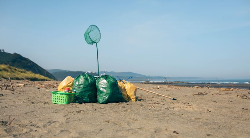 Garbage bags and utensils on the beach