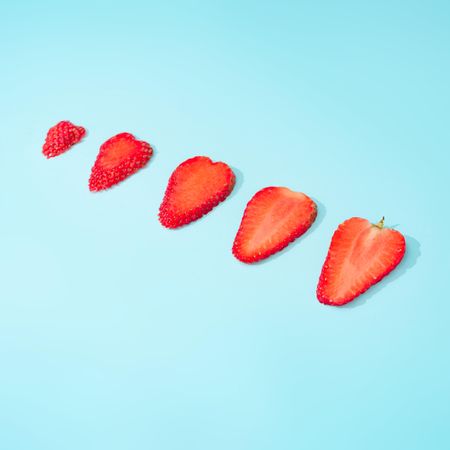 Slices of strawberries on blue background