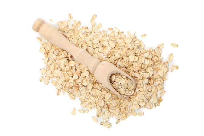 Scoop with oatmeal flakes isolated on plain background