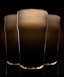 Glasses of beer with heavy dark foam