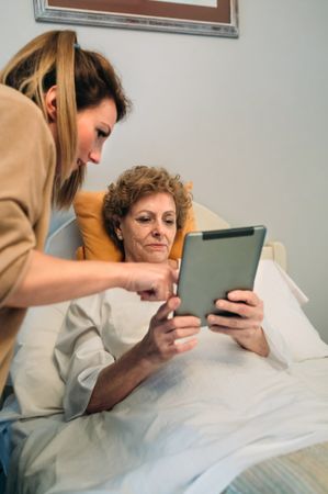 Female doctor showing results of a medical test on the tablet
