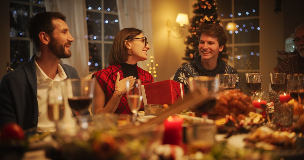 Family and Friends Gather at Home in the Evening for a Traditional Christmas Dinner with a Turkey Roast Feast