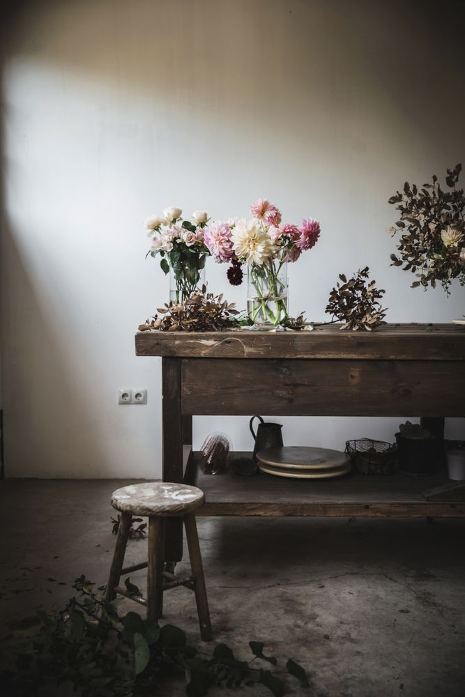 Bunches of flowers in vases on table
